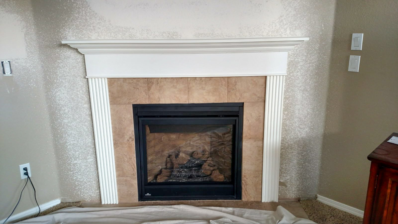 Finished basement living room with custom fireplace mantel in Coeur d'Alene, Idaho
