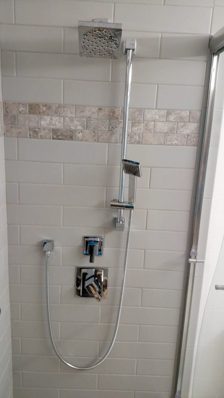 Modern shower system with travertine accent in Post Falls, Idaho