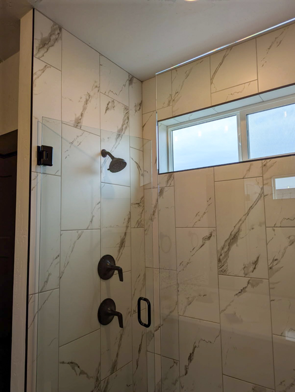 Marble walk-in shower with window in Coeur d'Alene, Idaho