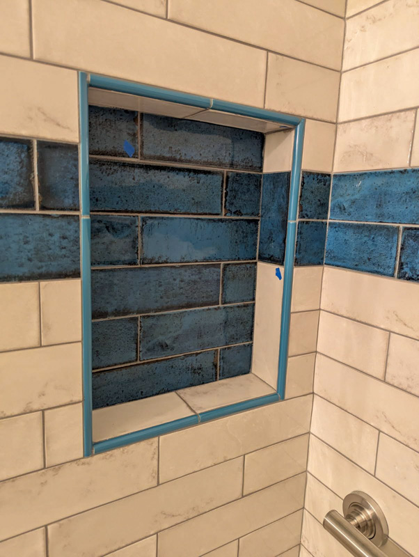 Blue subway tile shower niche in Post Falls, Idaho